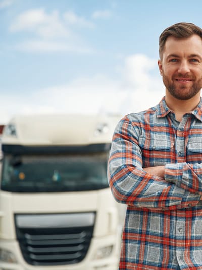 man standing with arms folded in front of motorhomes as the first time RV buying guide